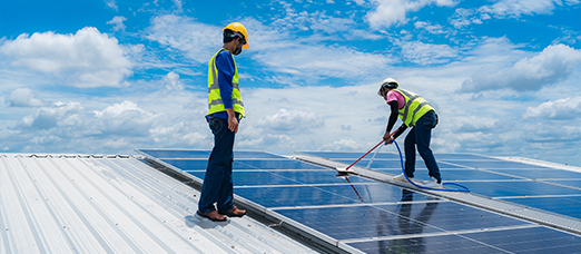 Solar panel technicians conducting monitoring and maintenance tasks