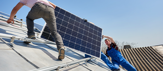 A solar panel technician safely removes a solar panel