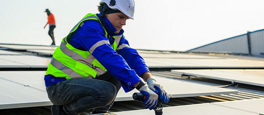 A solar panel technician installing a solar panel